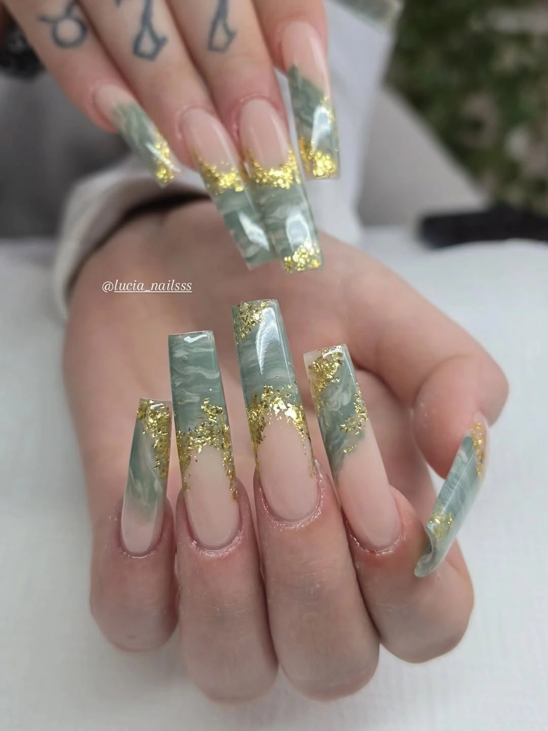 Long clear square nails with mint panels and gold fleck accents