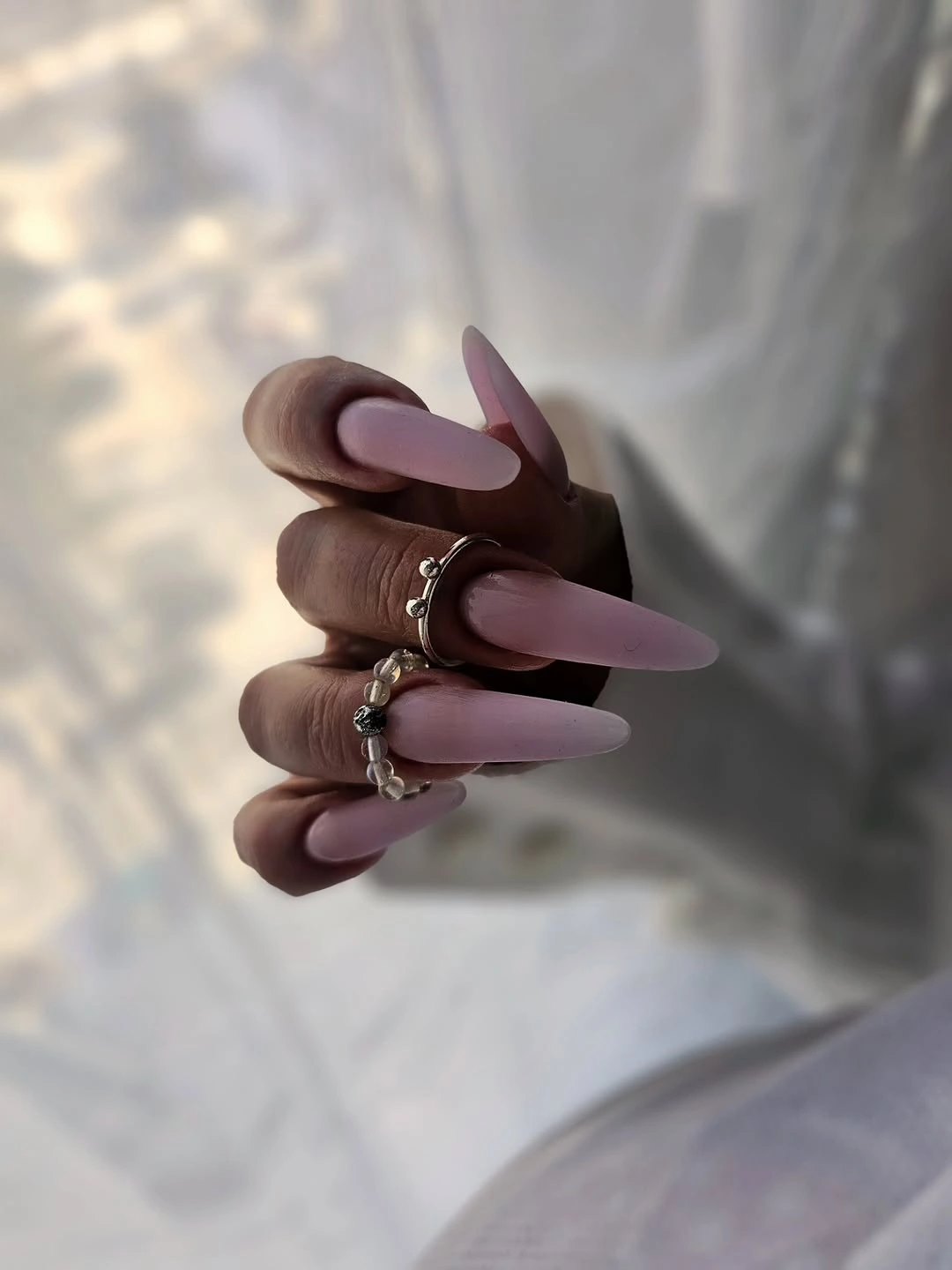 Long matte mauve stiletto nails in a muted purple shade