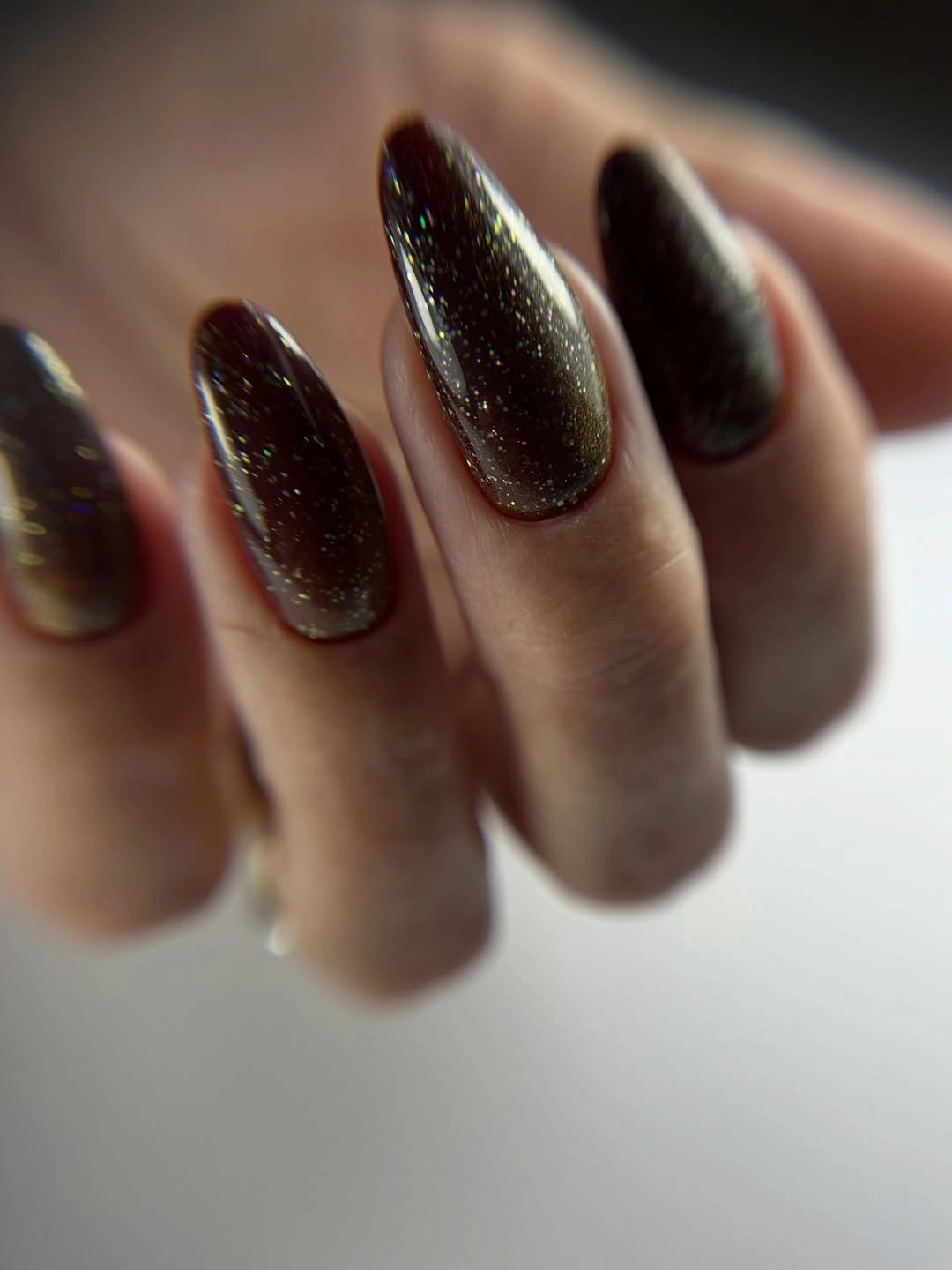Dark chocolate almond nails with subtle reflective sparkle