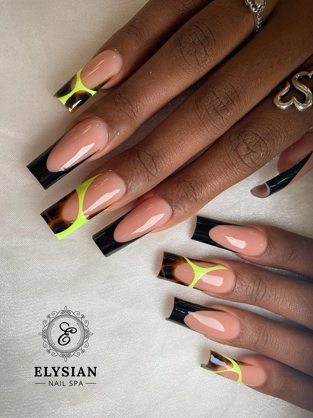 Nude square nails with black French edges and bright corner blocks