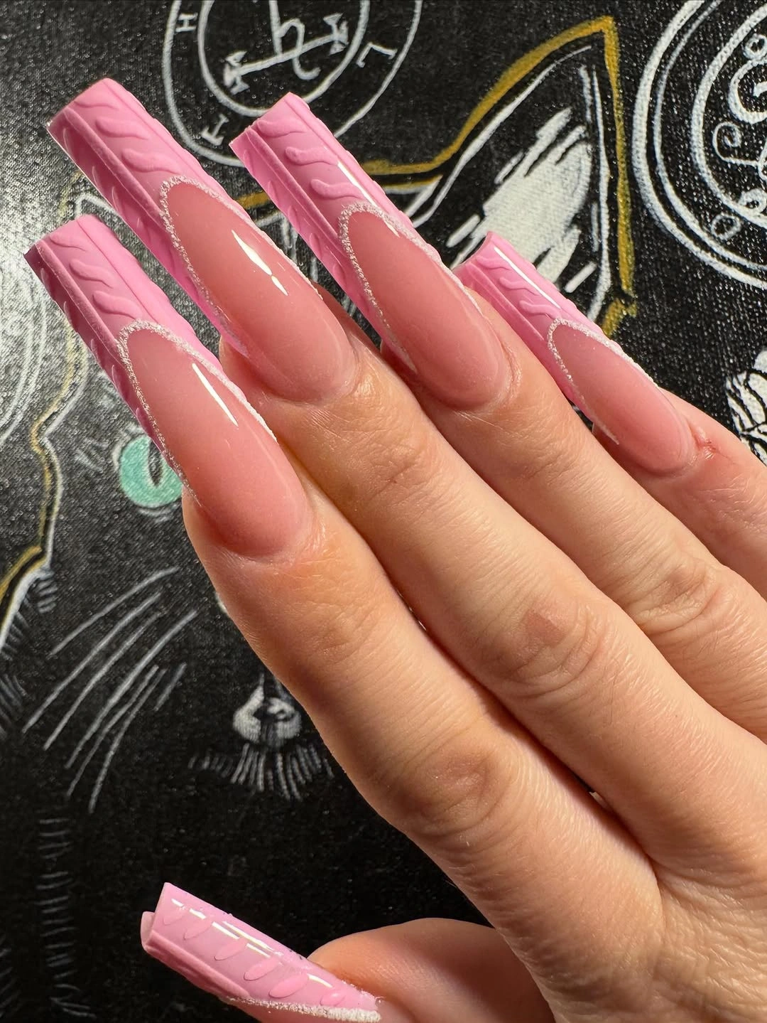 Long glossy pink nails with curved raised-looking tip detail