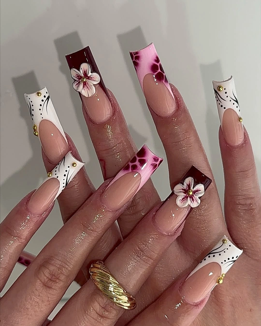 Long pink tapered nails with white floral French tip details
