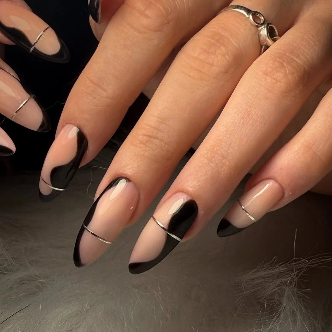 Sheer nude almond nails with thin black curved French edges