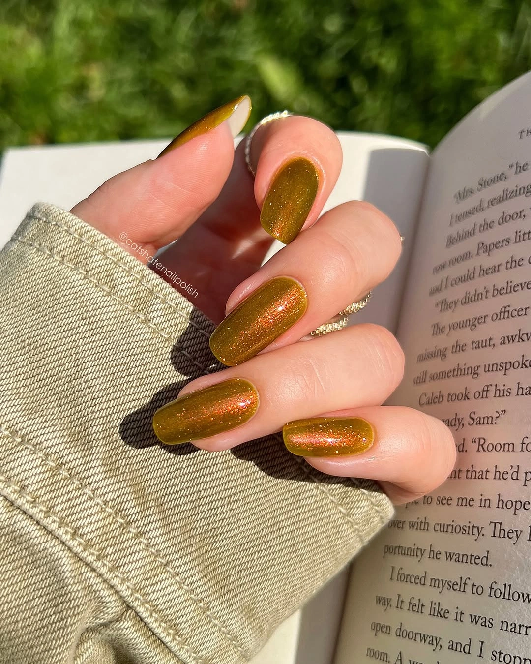 rounded square manicure in olive green with coppery reflective shimmer