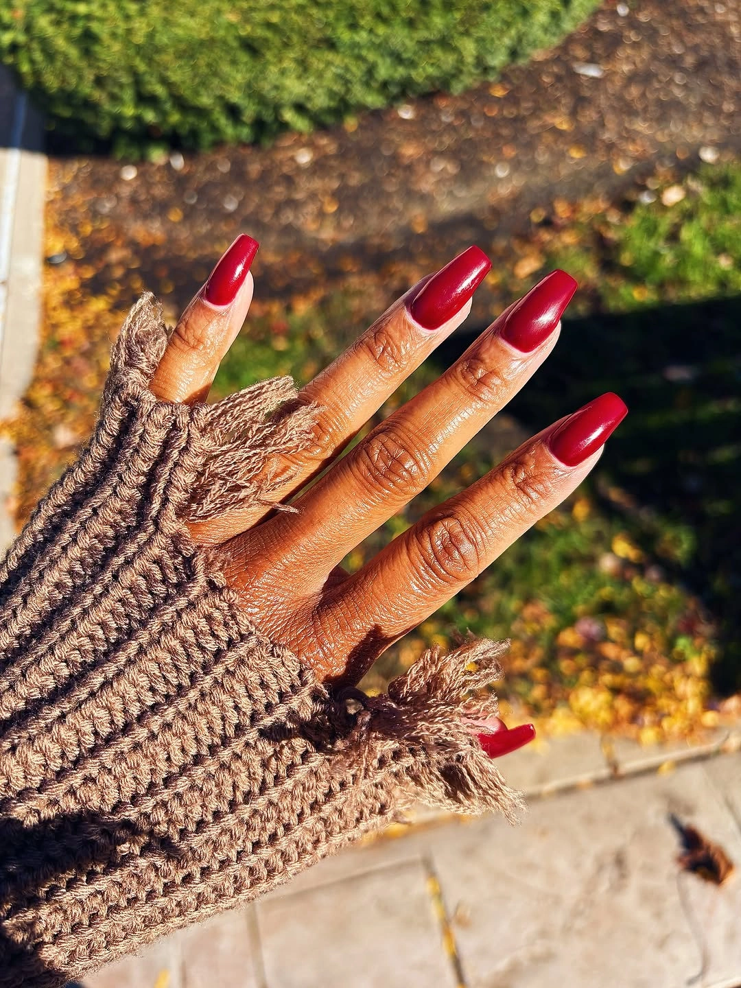 long coffin manicure in solid cranberry red with glossy finish