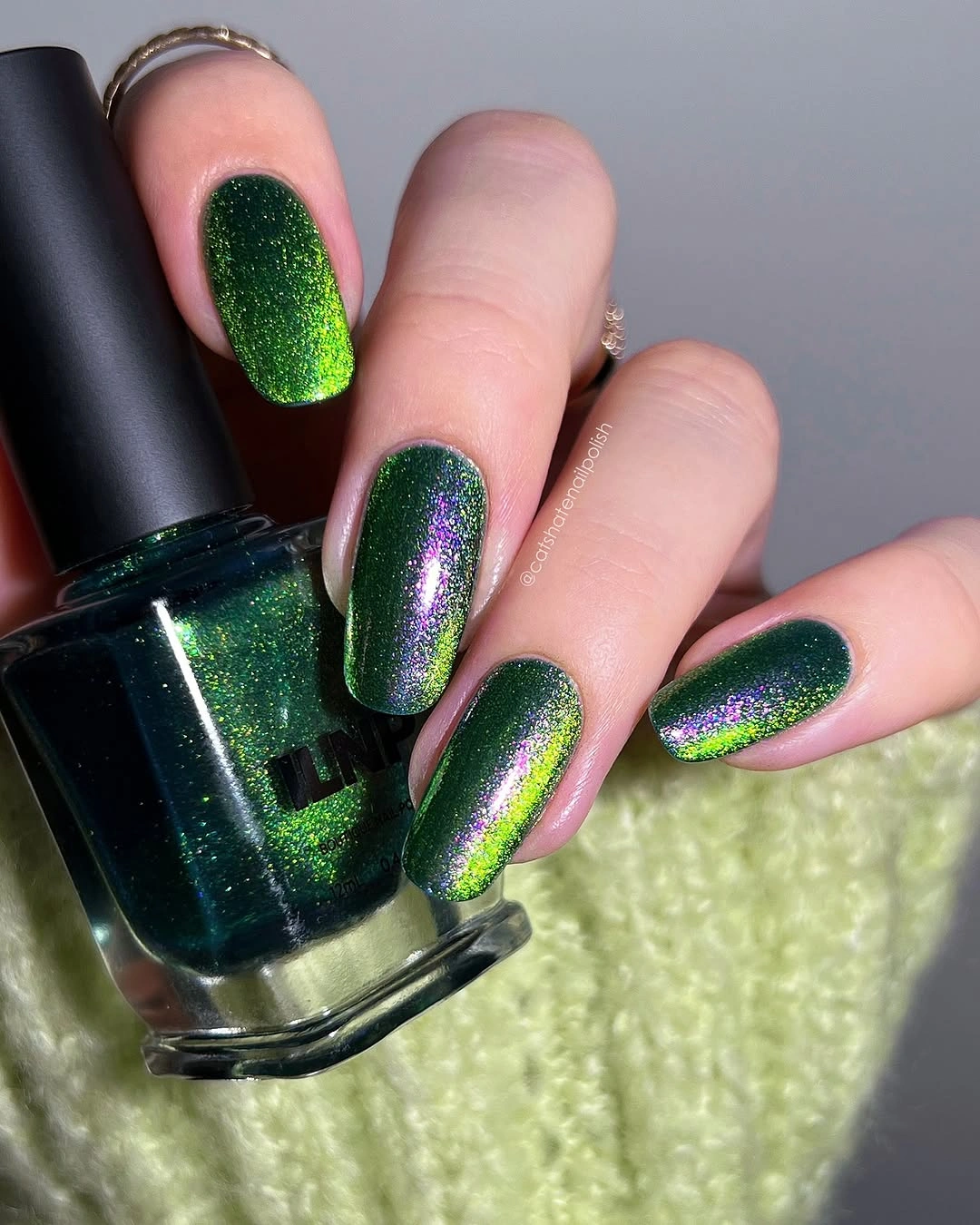 medium rounded square manicure in emerald green shimmer with purple and lime reflective flashes