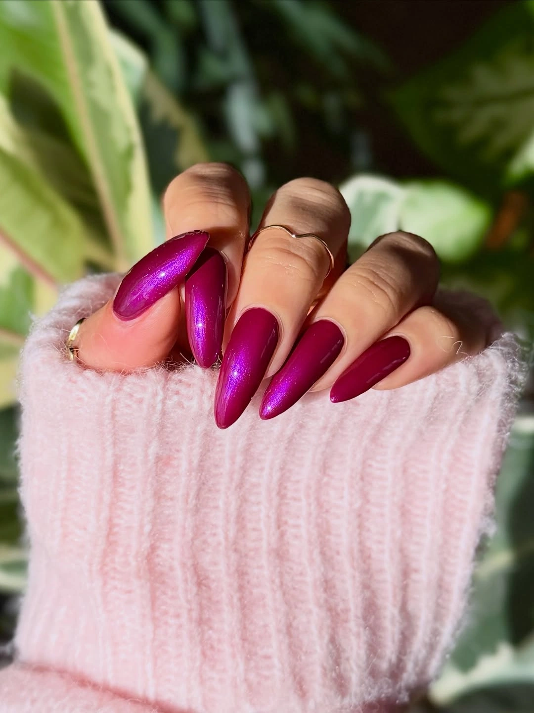 long stiletto nails in glossy magenta with fine shimmer