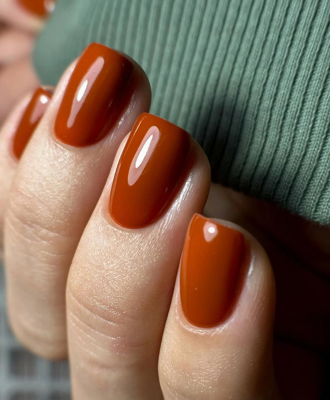 short squoval nails in glossy burnt orange fall color
