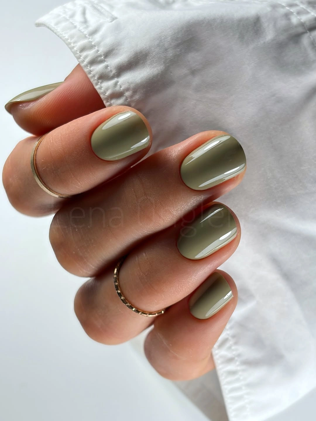 short square olive nails with thin white curved accents