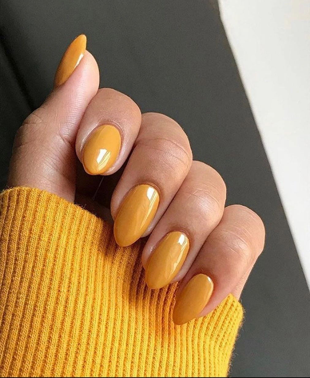 medium almond nails in glossy mustard yellow