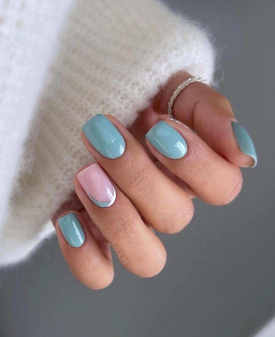 short rounded nails in glossy sky blue with one pink accent