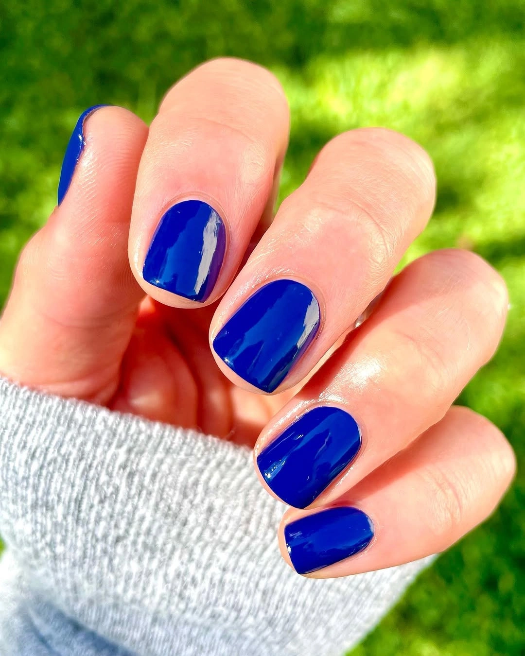 short squoval nails in glossy cobalt blue