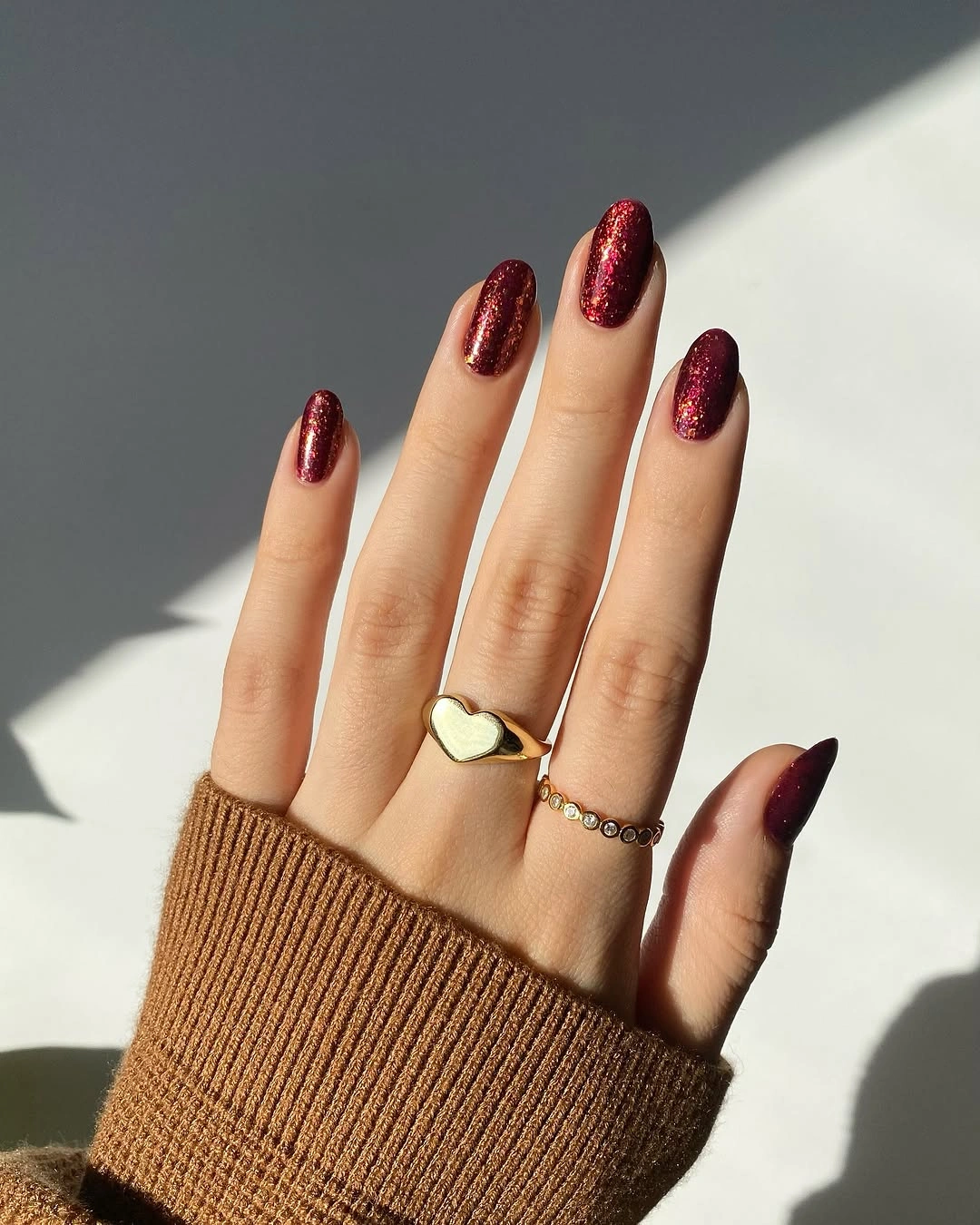 Long almond nails in a saturated deep berry shimmer
