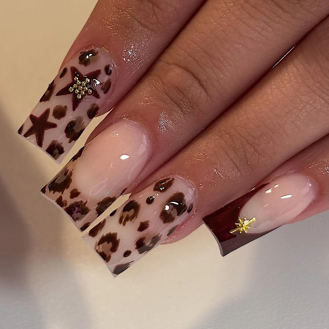 Long square nails with brown tortoise patches white bands and gold details