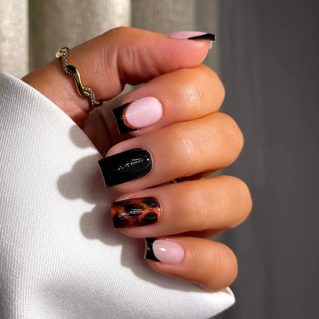 Medium square nails with pink black and warm patterned accents