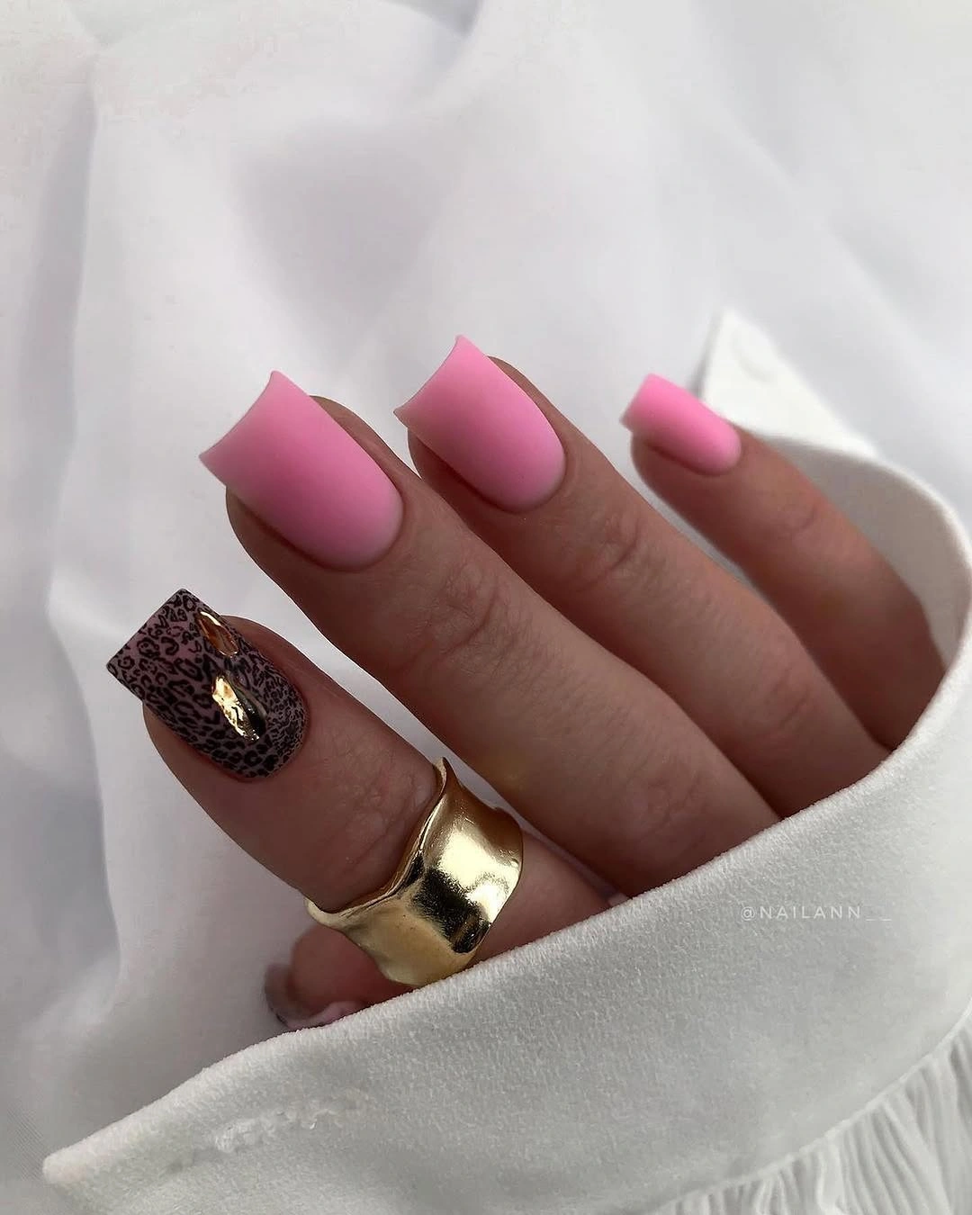 Long square pink nails with one dark reflective accent nail