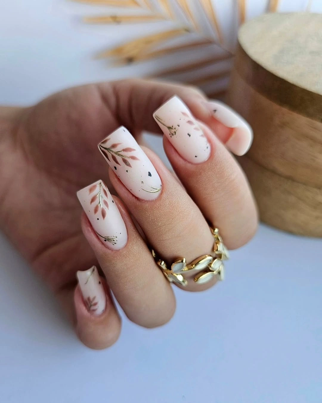 Milky square nails with delicate brown branch line accents
