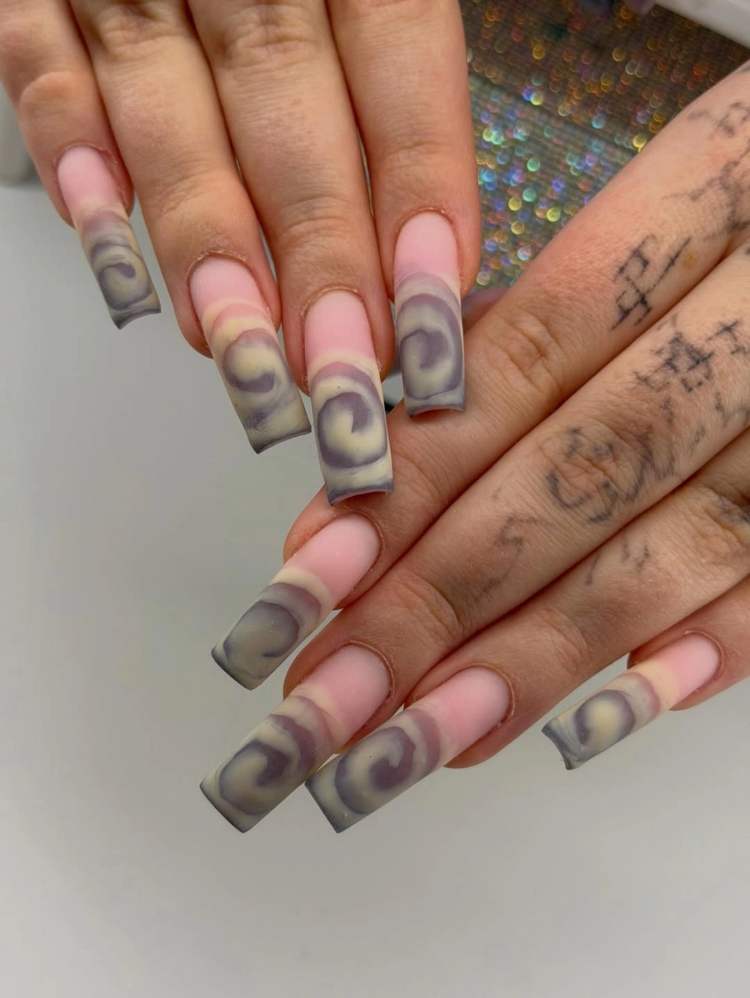 Long square nails with smoky lavender and mauve curved bands