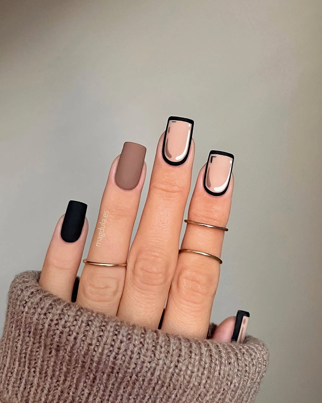 Short square nails with black outlined pale geometric tips