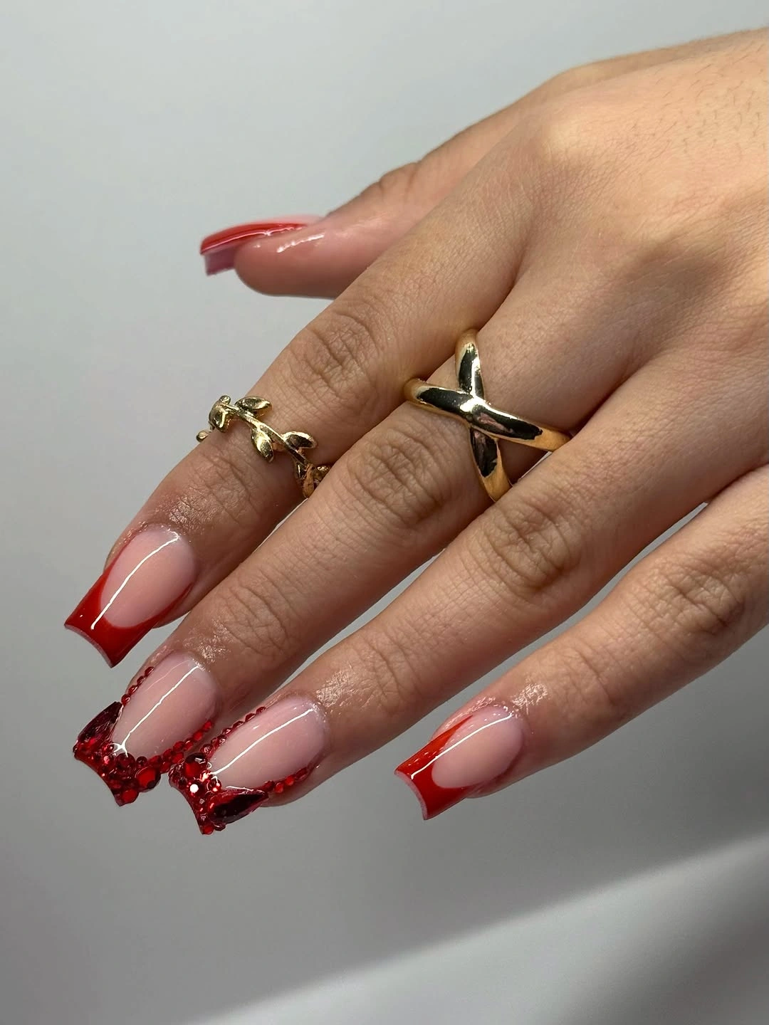 nude square nails with vivid red tips and dense red accents