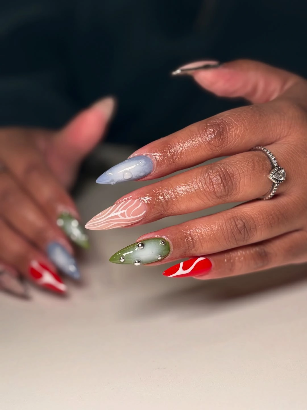 mixed pointed nails with green, red, blue, and white accents