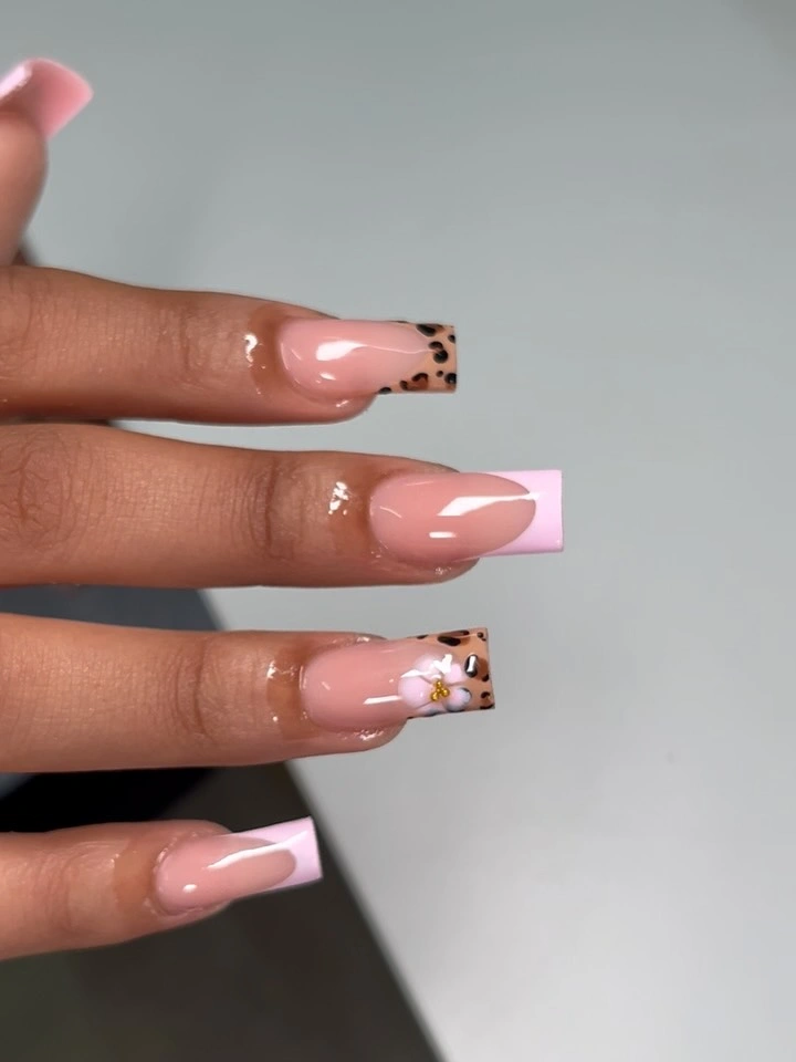 pink square French nails with one patterned accent