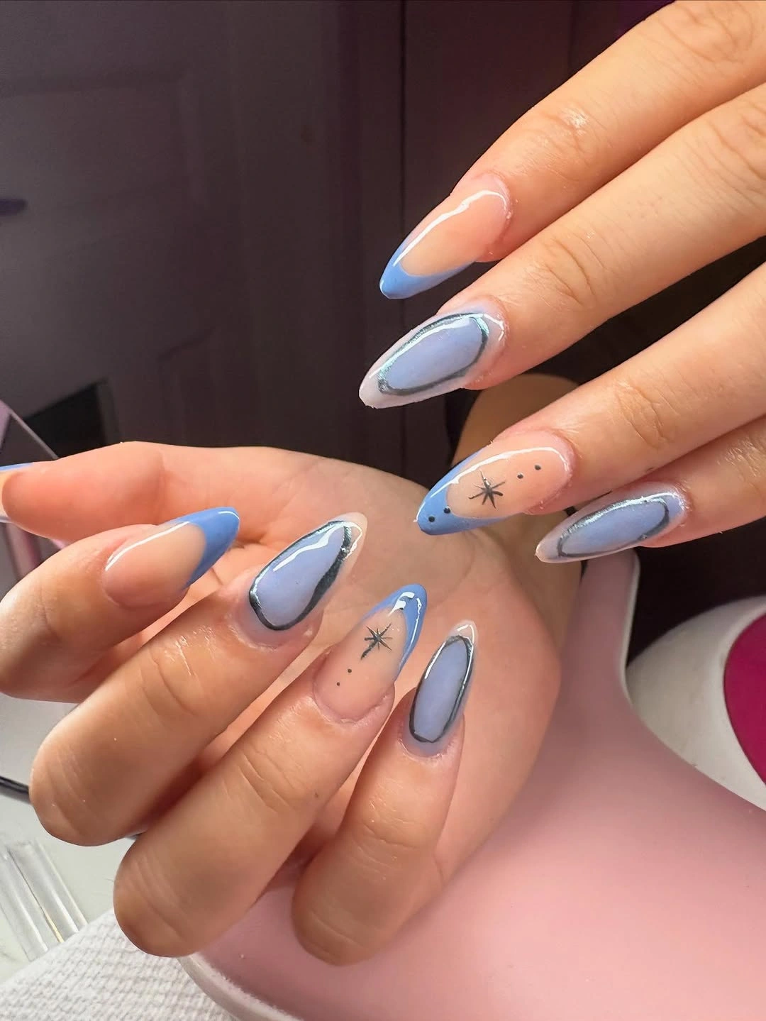 pink almond nails with blue-lilac outlines and star marks