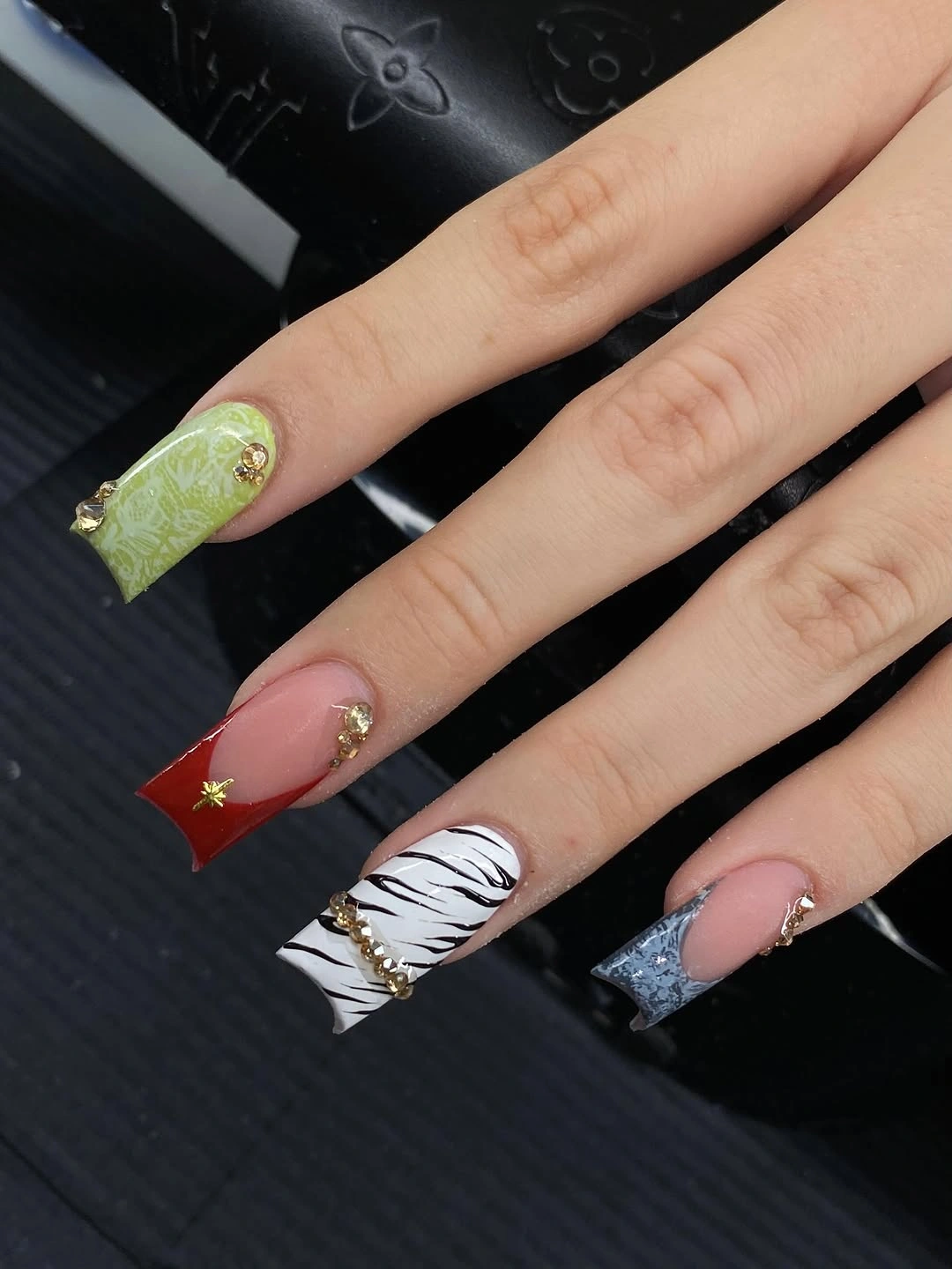nude square nails with lime, red, zebra, and blue tips