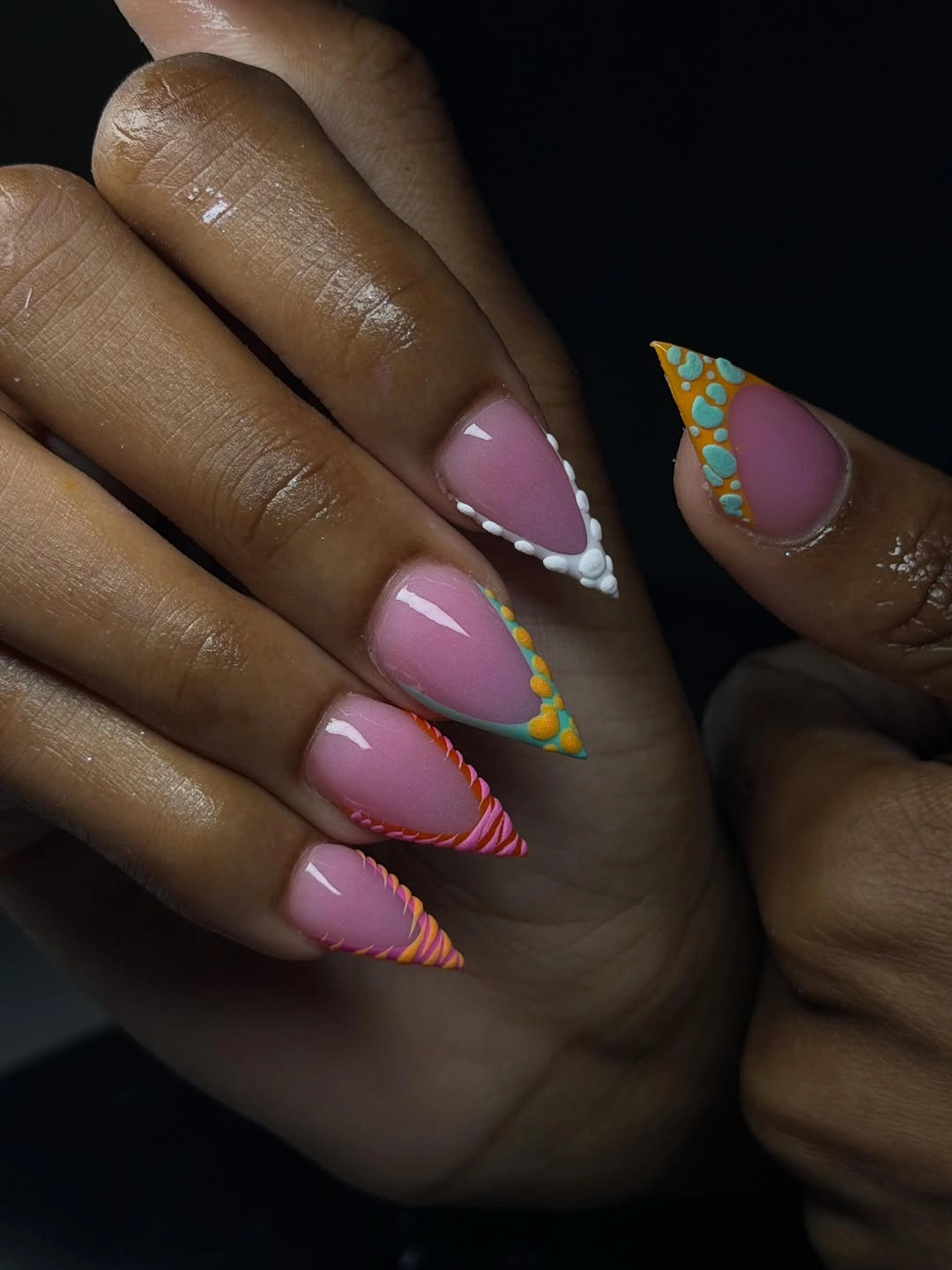 pink nails with layered blue, lime, coral, and yellow bands