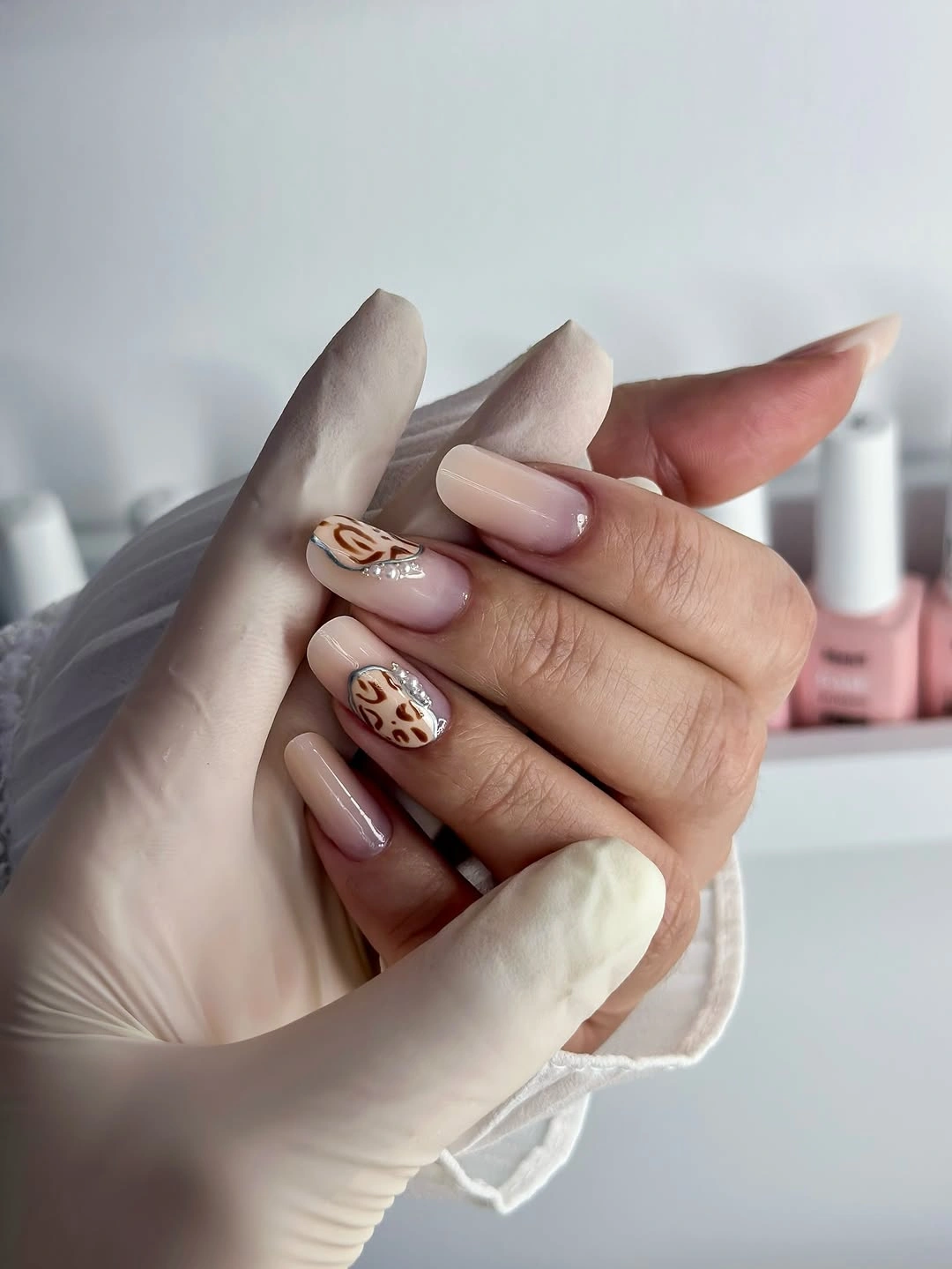 pink almond nails with brown and white abstract accents