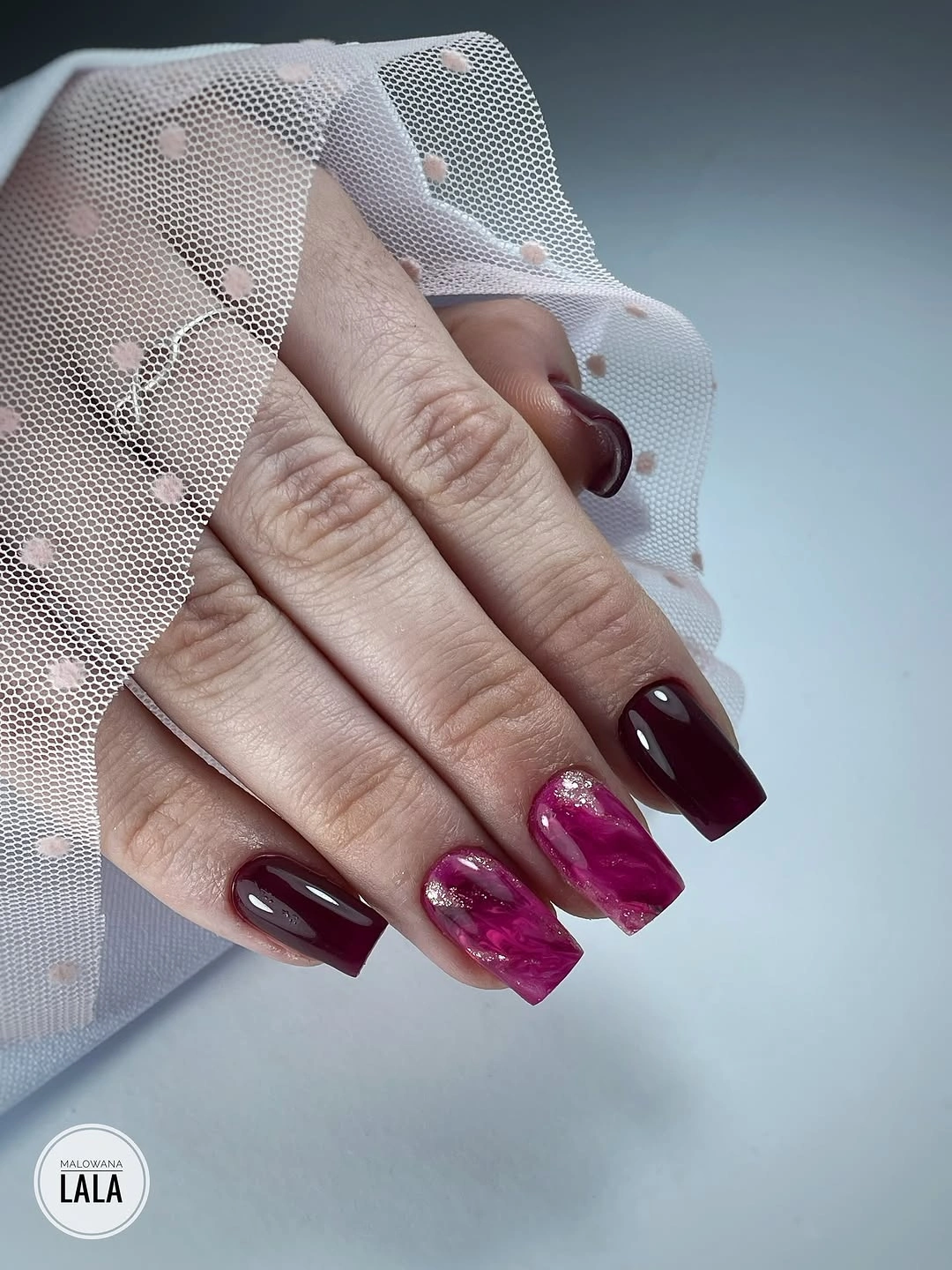 Burgundy square nails with bright magenta marble accents