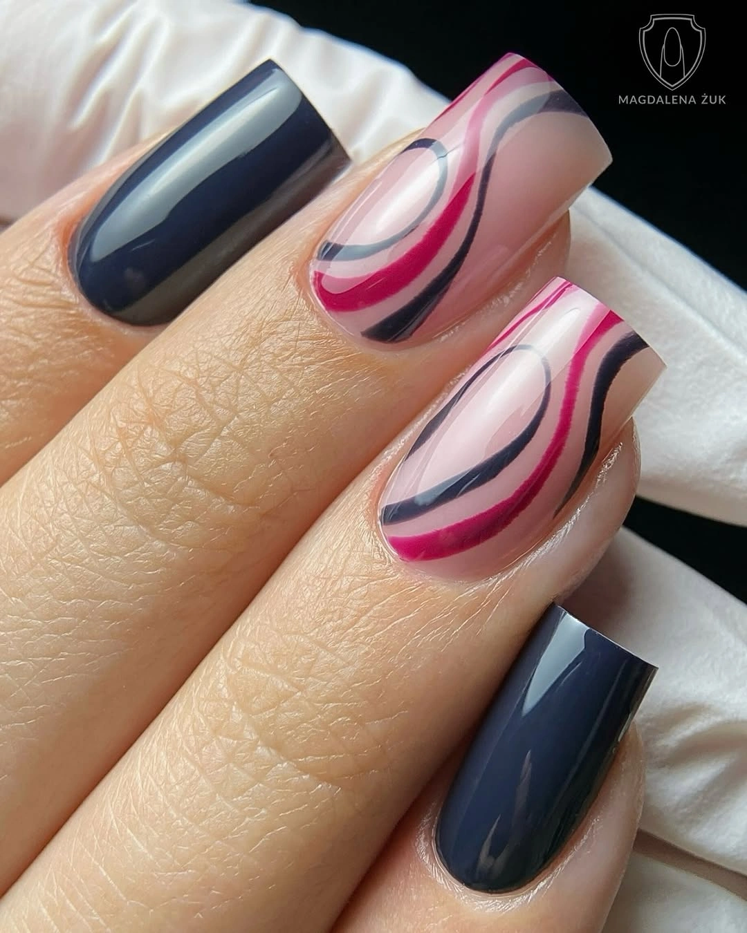 Sheer pink nails with navy and berry curved arcs