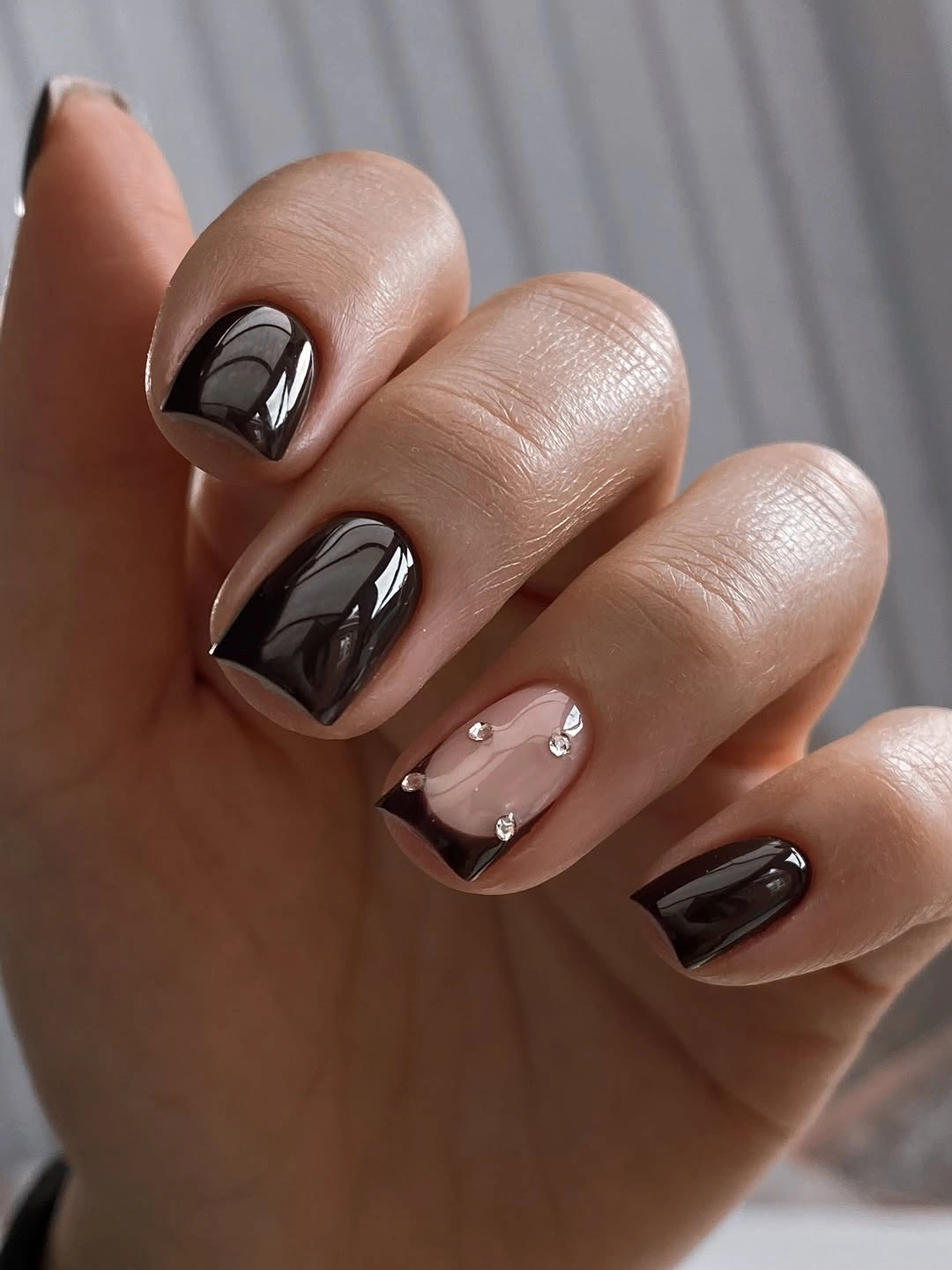 Dark brown square nails with one nude jeweled accent