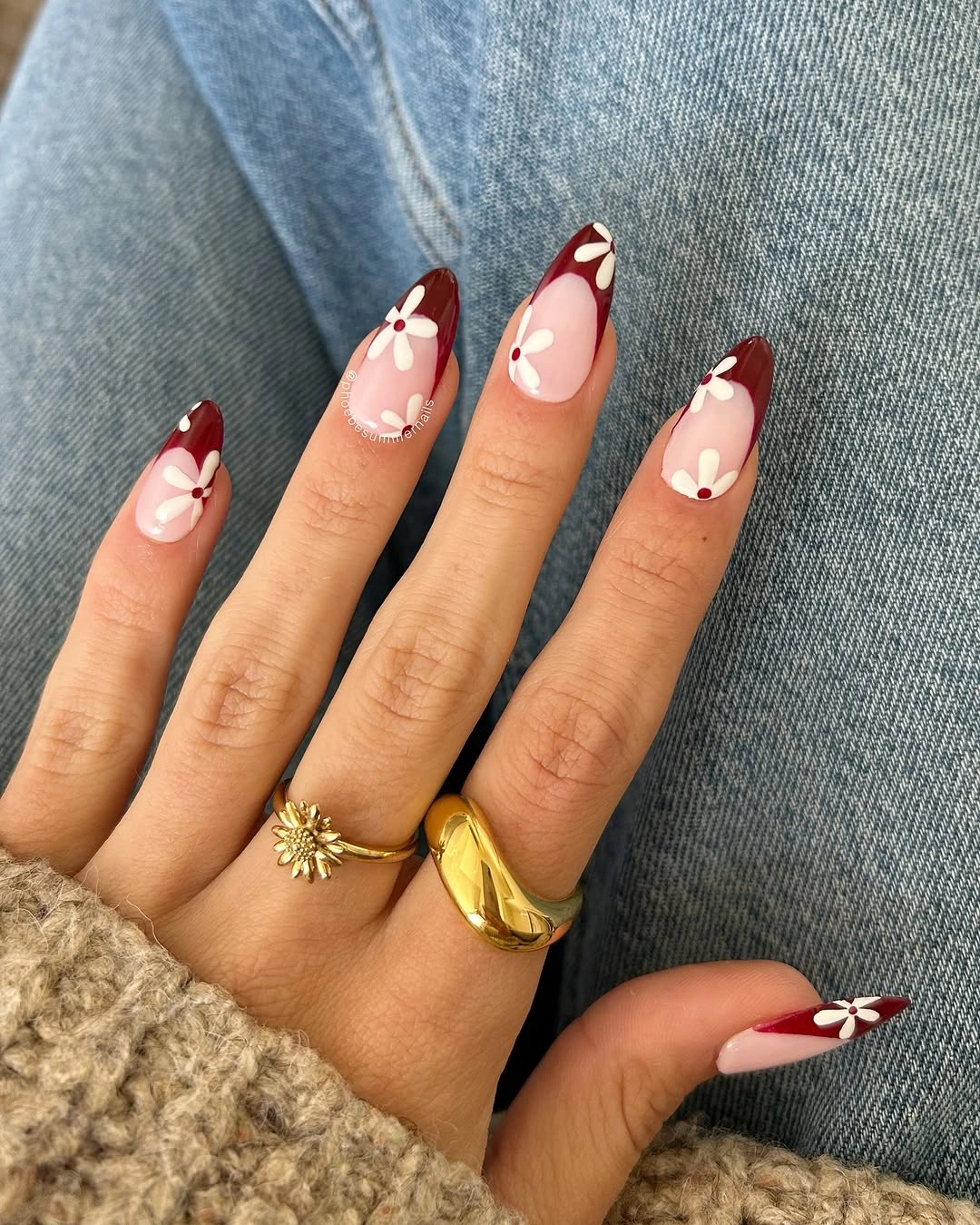 Burgundy French almond nails with white daisy-like flowers