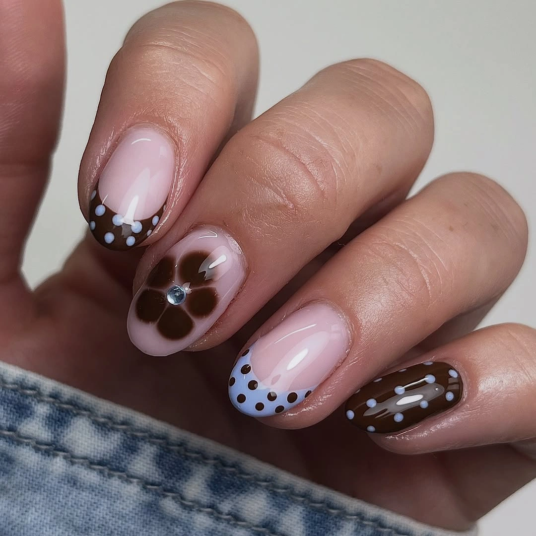 Rounded fall nails with brown dots and flower accent
