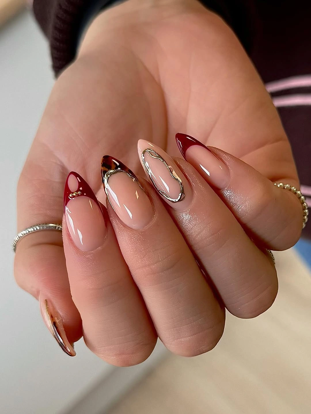Medium almond nails with burgundy black outlines and warm curves
