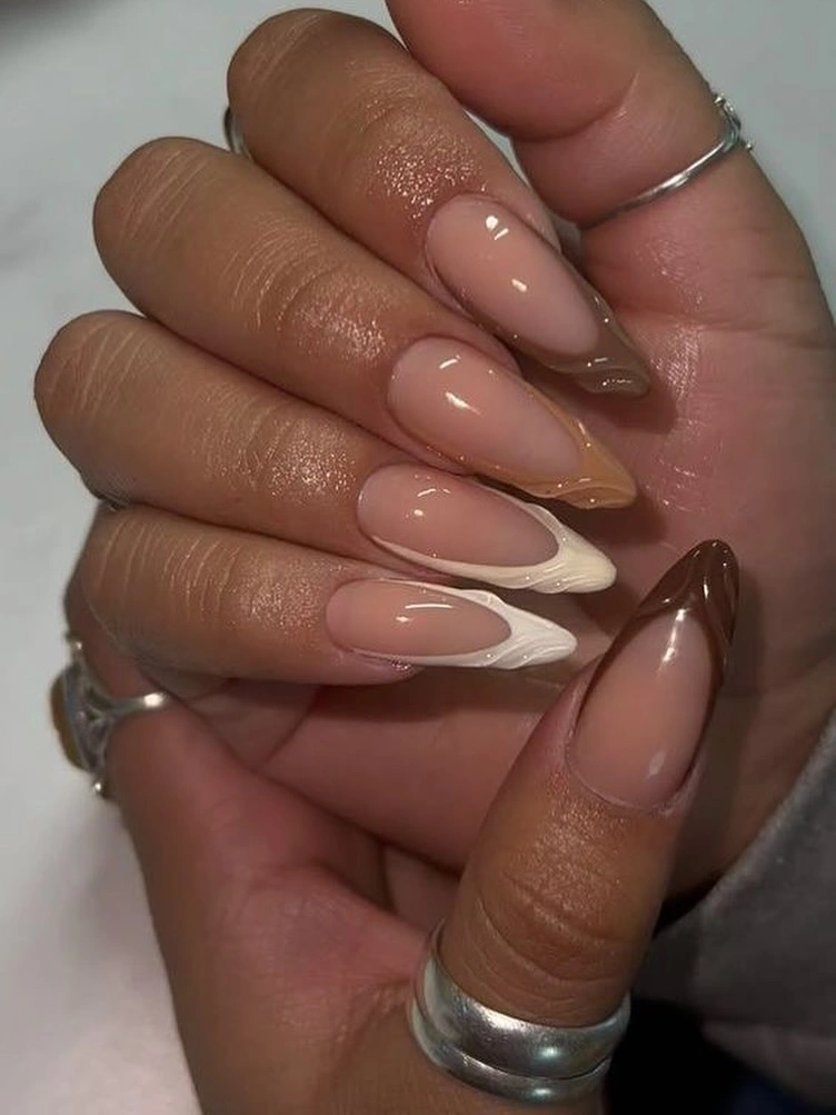 Medium almond nails with alternating white and brown French tips