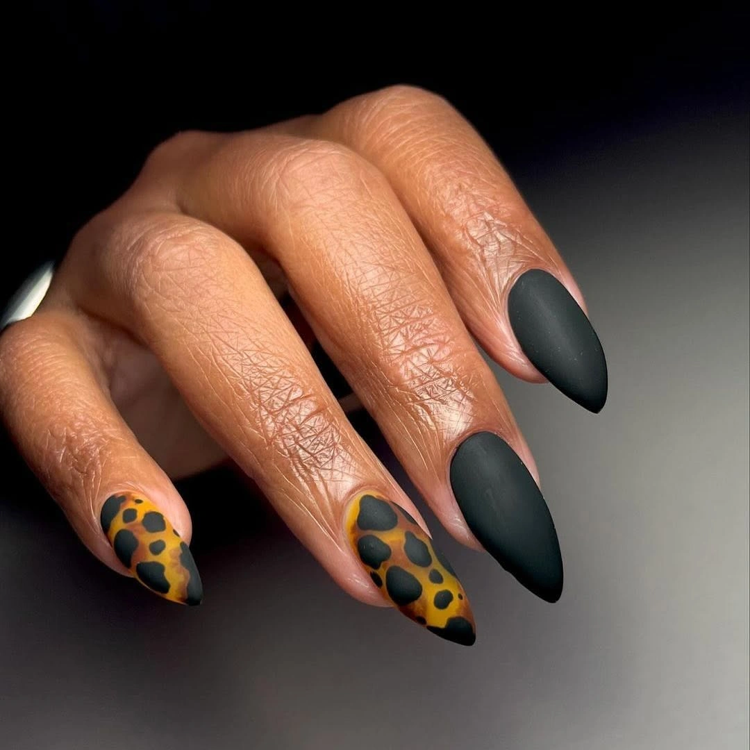 Matte black almond nails with brown leopard accents