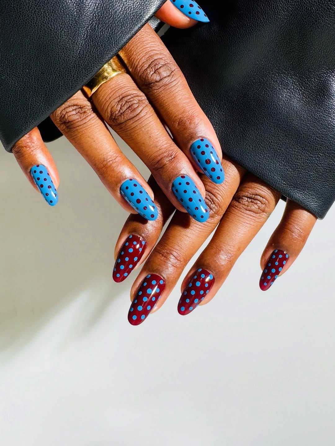 Blue and burgundy polka-dot almond nails