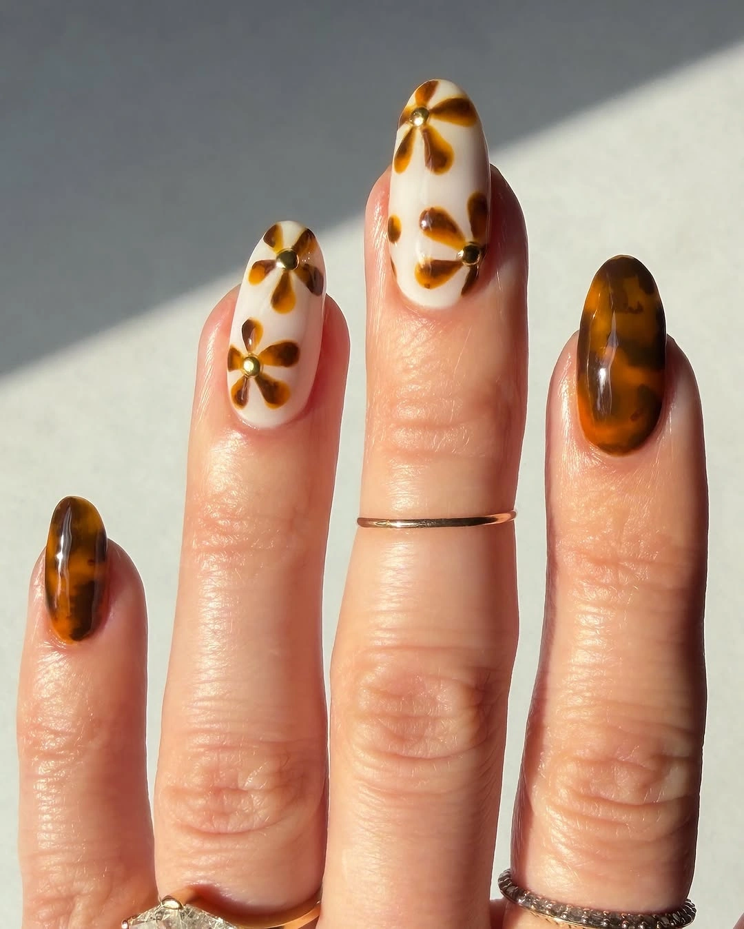 Cream floral nails with tortoiseshell brown accents