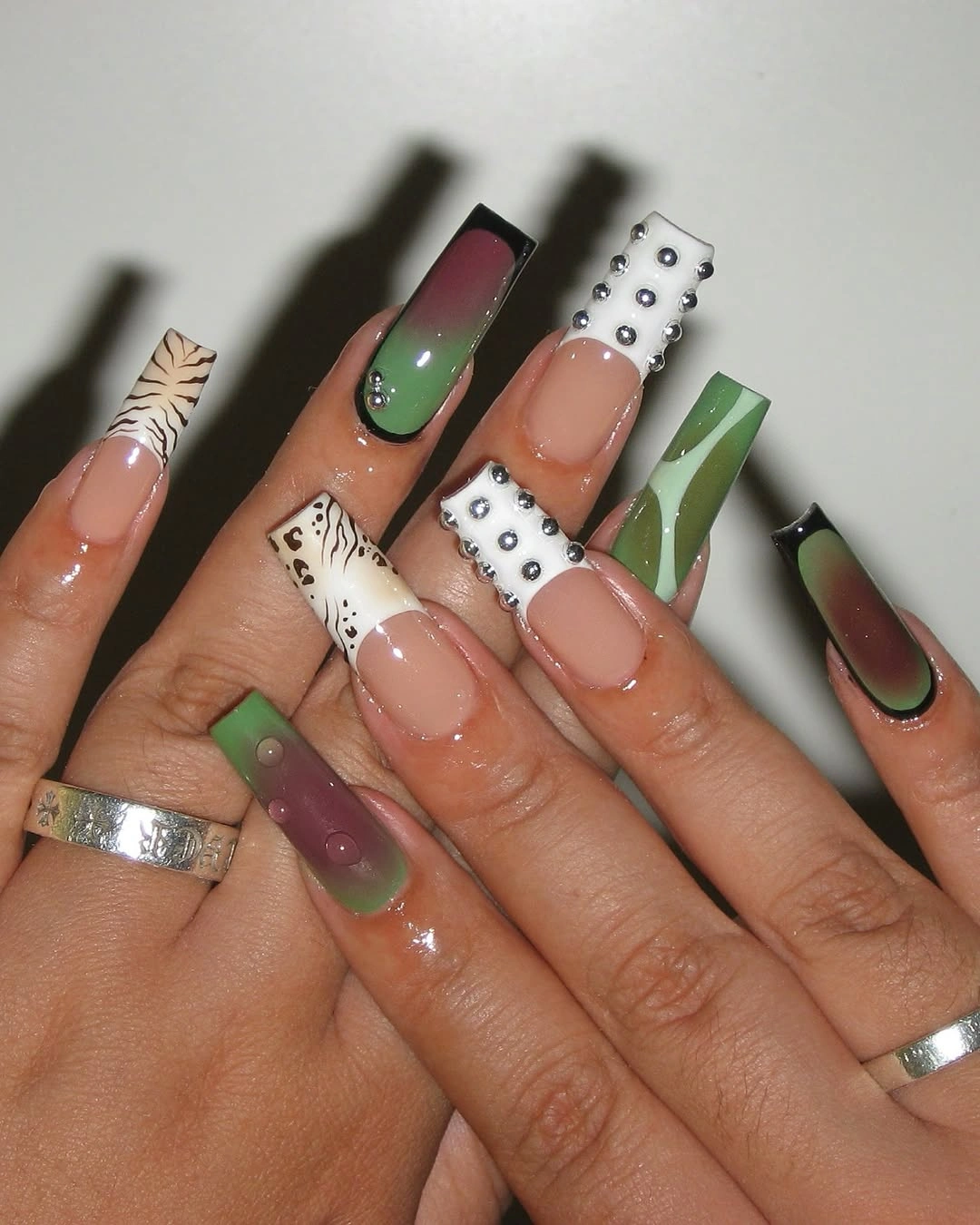 Long green square nails with studs gradients and white accents
