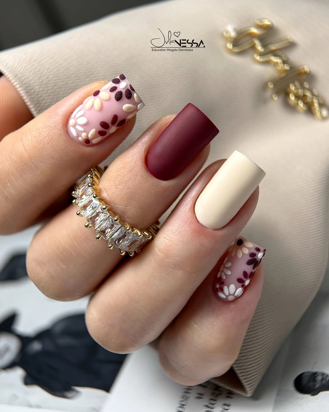 Cream and burgundy square nails with petal accents