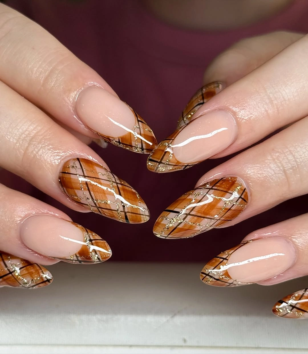 Almond nails with amber plaid French tips