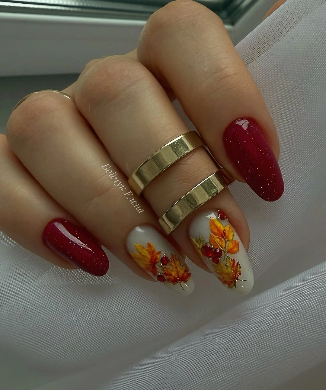 Berry glitter oval nails with pale orange floral accents