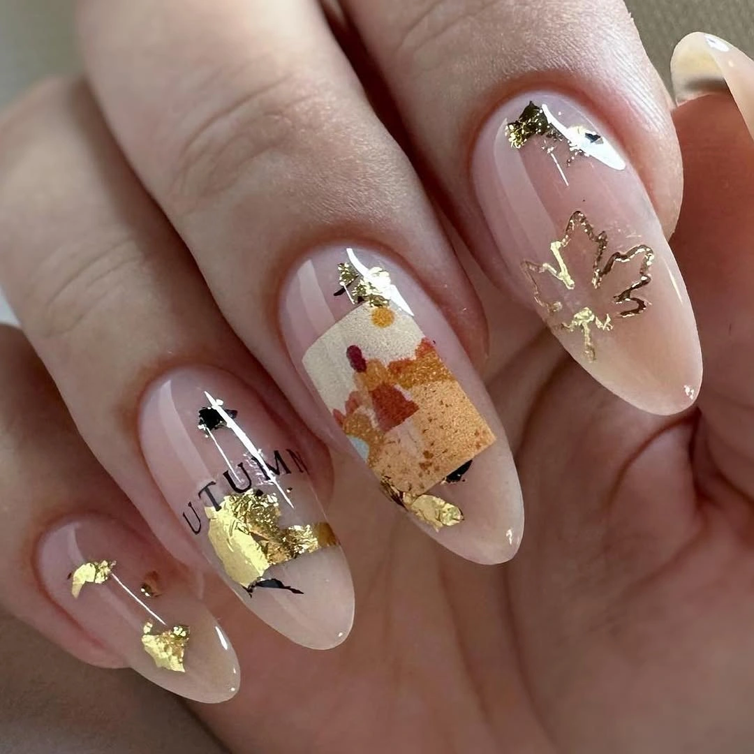 Sheer pink almond nails with gold foil and autumn collage accents