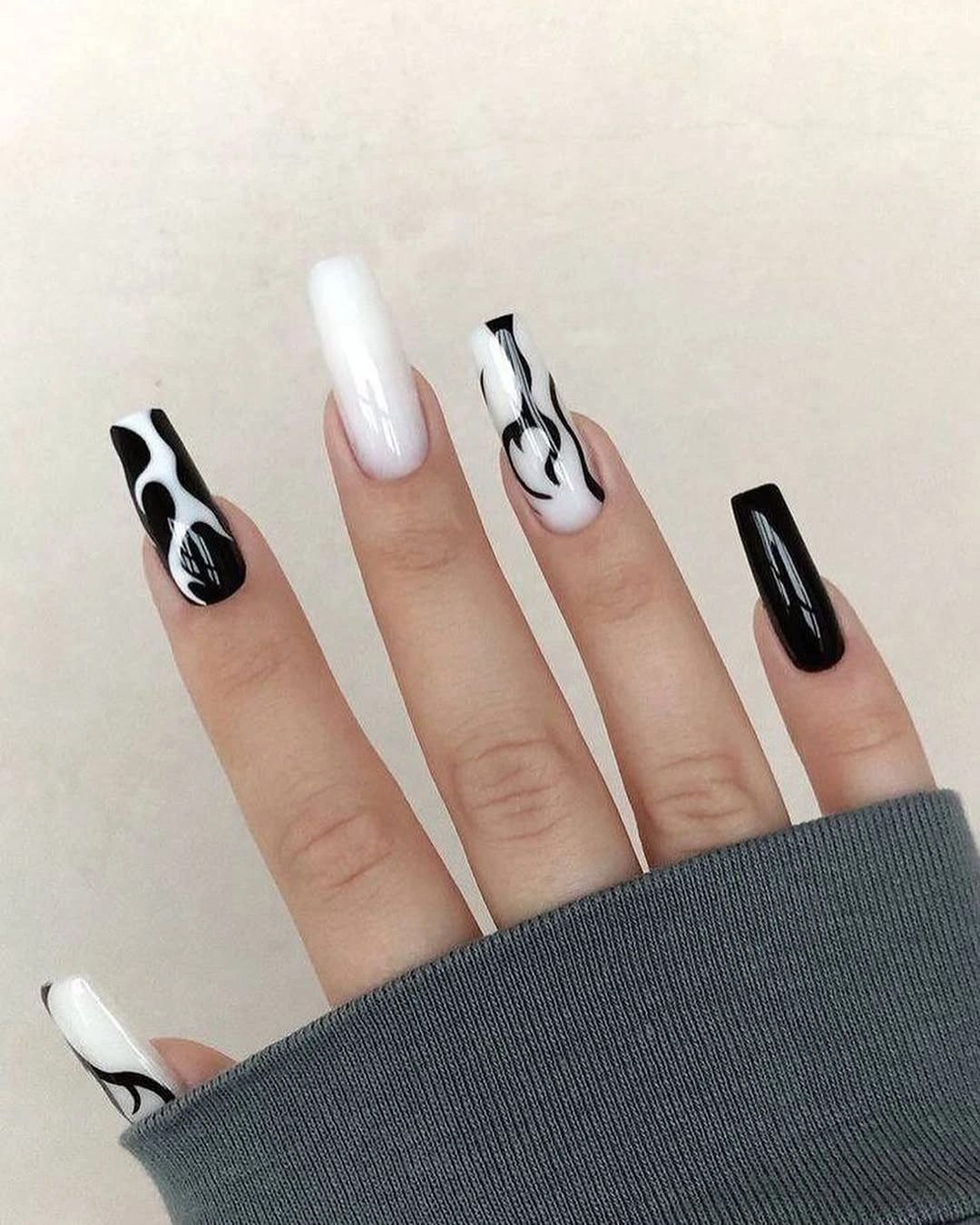 Long square monochrome nails with sparse black curved line art