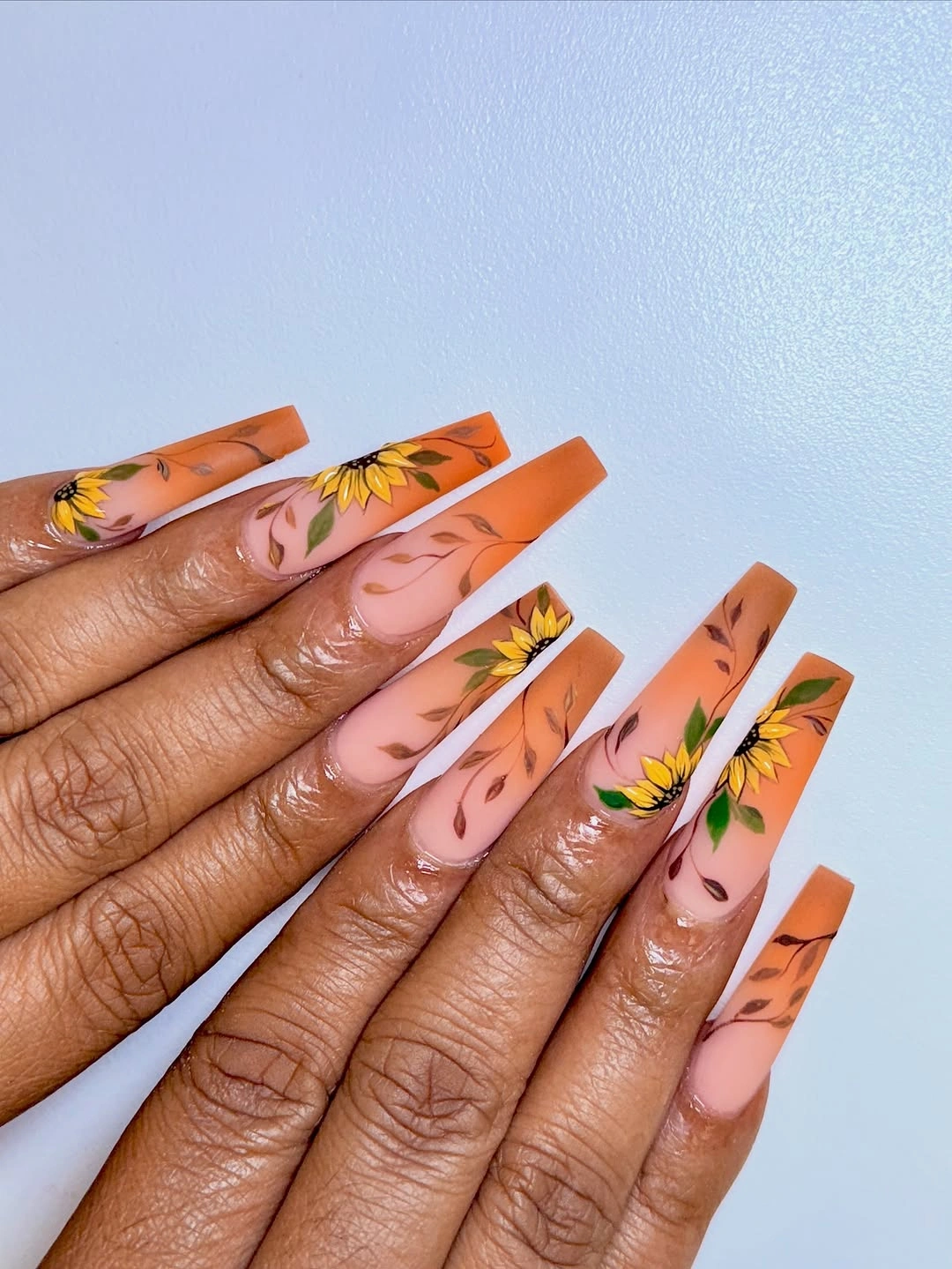Orange square fall nails with yellow floral botanical accents