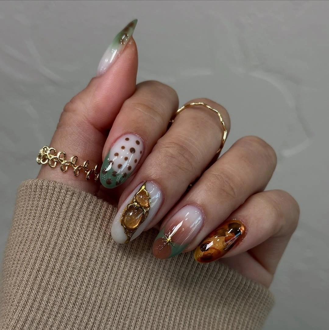 Milky green amber almond nails with botanical gold accents