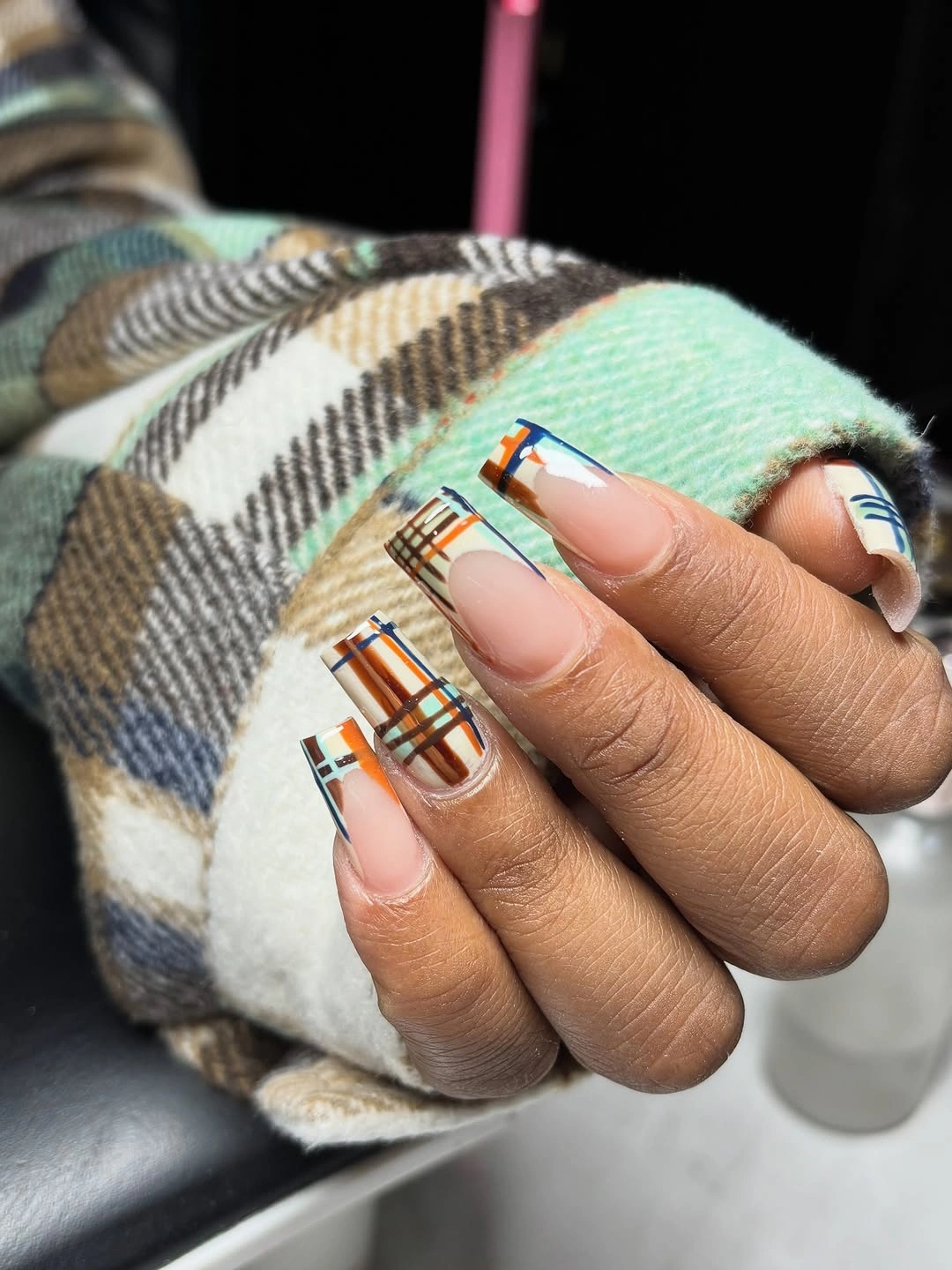 Nude square nails with colorful plaid-style fall borders