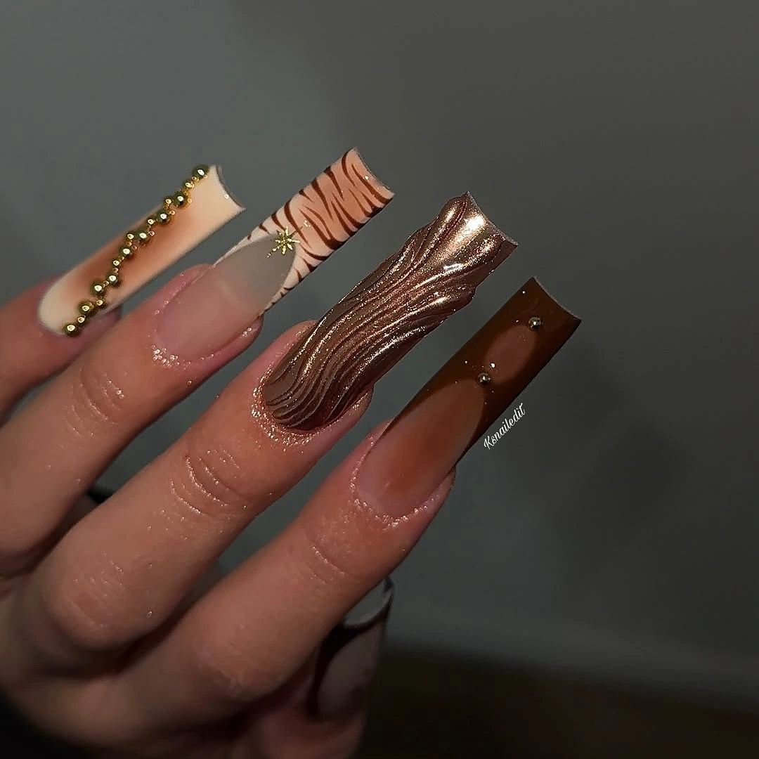 Long brown square nails with stripe-like gold accents